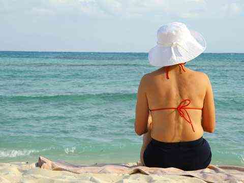 A woman relaxing at the Mediterranean Sea