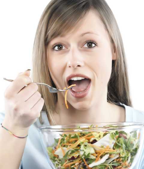 Girl eating salad Beautiful girl eating a big bowl of salad