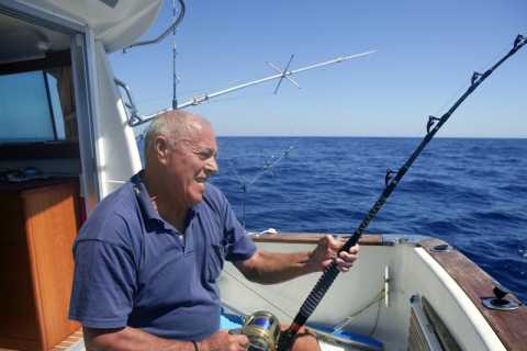 A senior gentleman fishing in the Mediterranean Sea