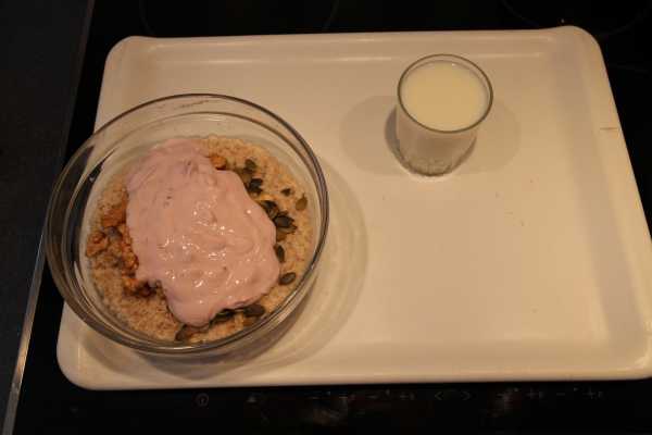 Step 4 for homemade muesli. Yogurt has been added to the bowl.